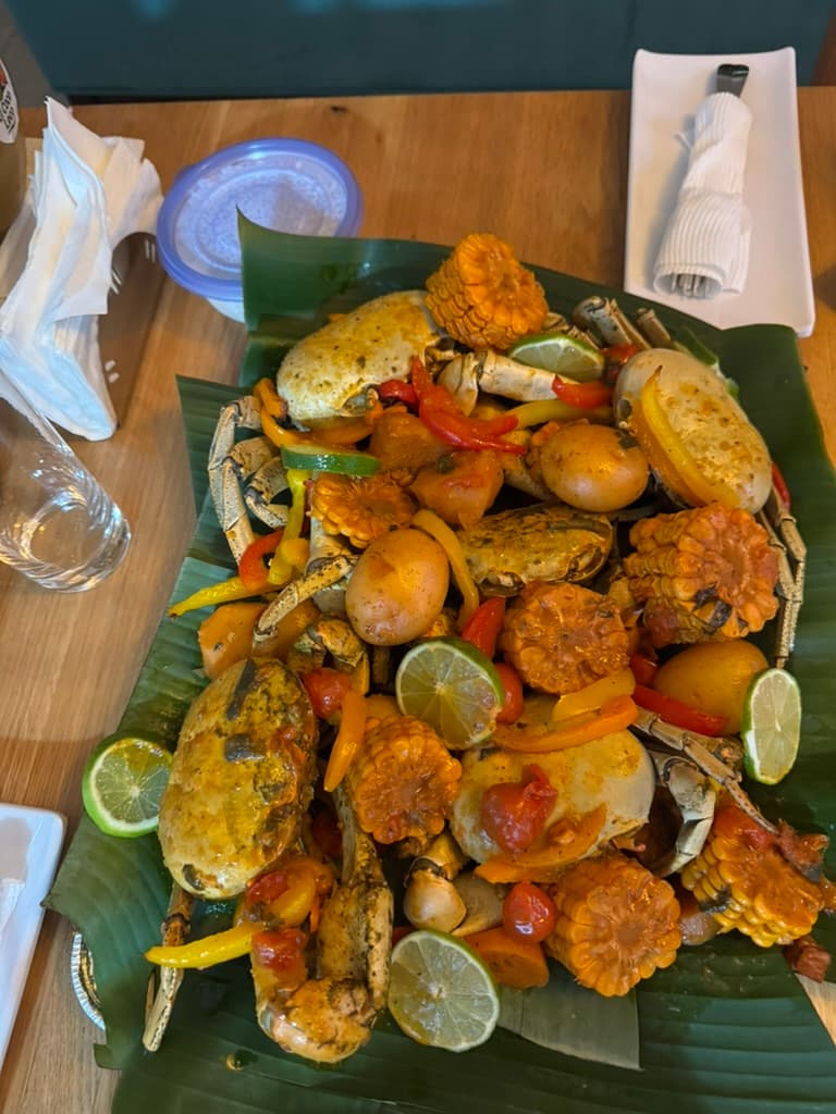 Seasonal local crab feast with corn, lime, and plantain leaves
