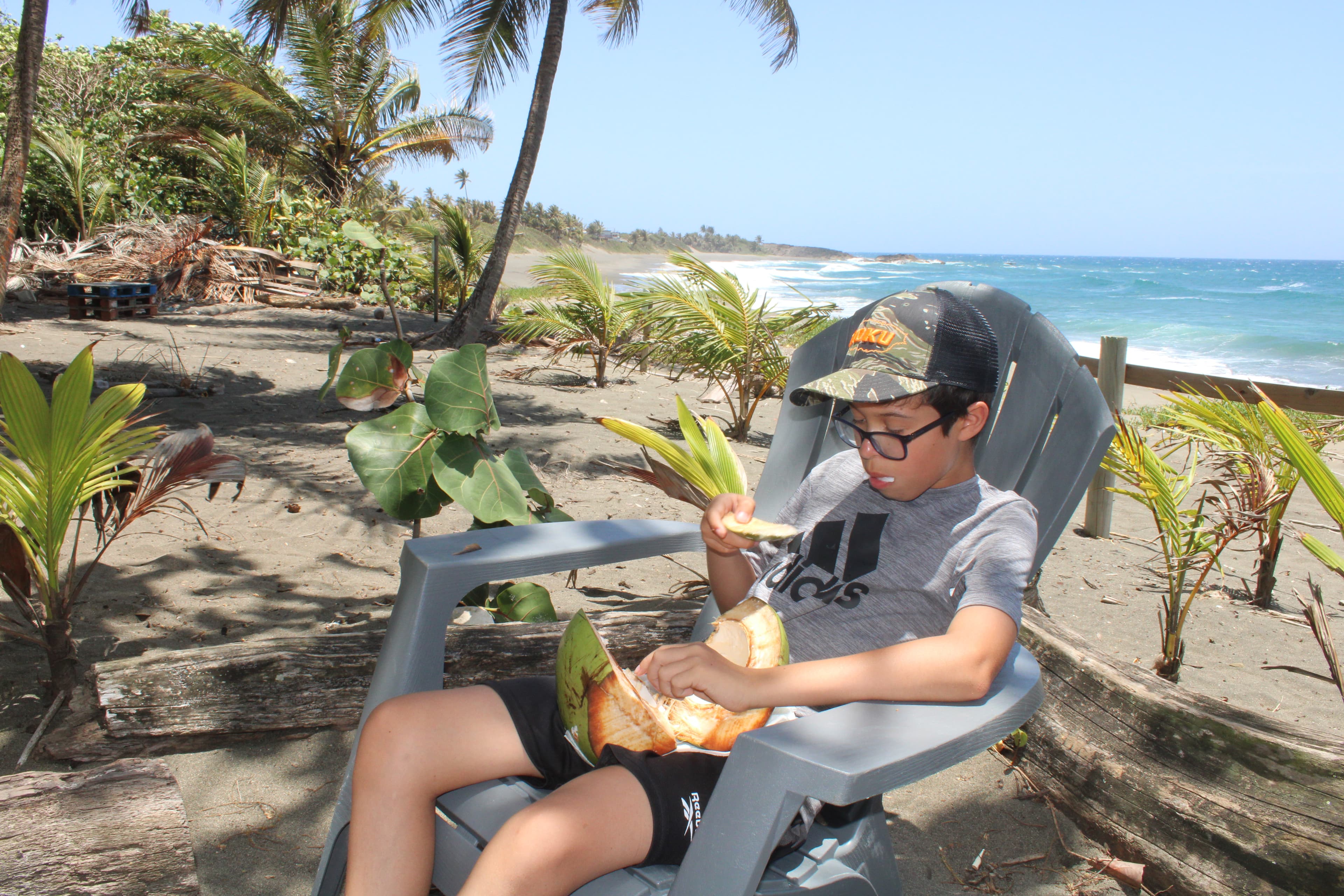 Eating fresh coconut meat at a local coconut stand near Arenas Negra